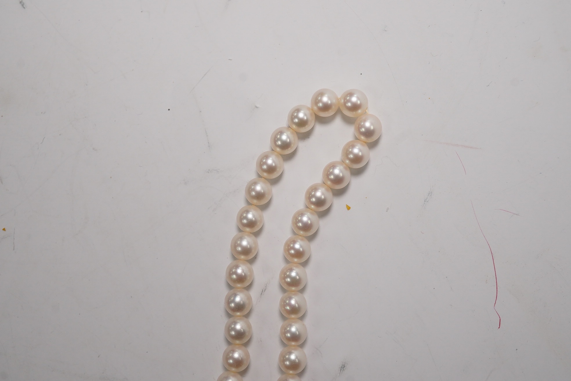 A Mikimoto single strand cultured pearl necklace, 36cm, with Mikimoto pouch. Condition - fair to good